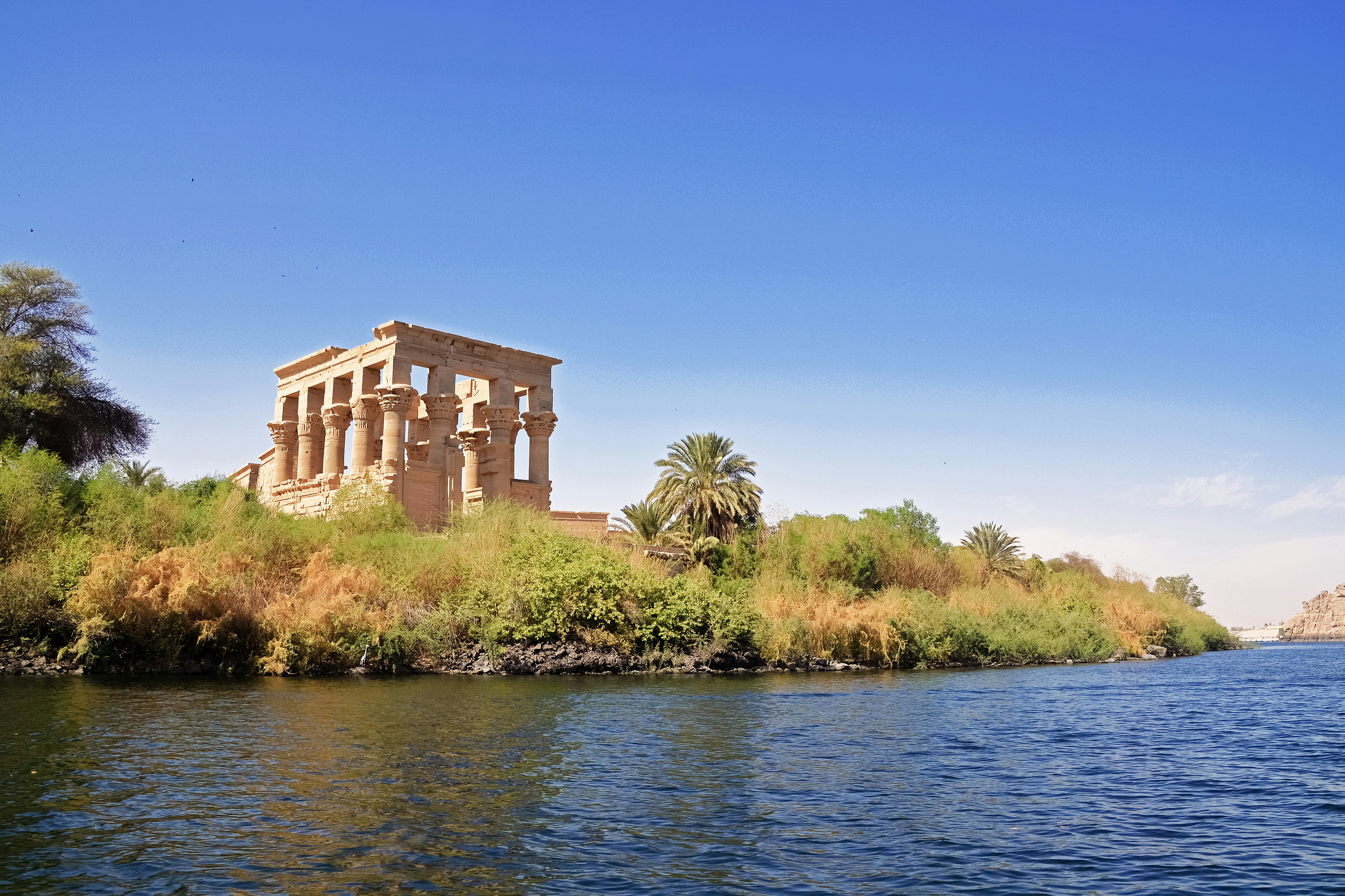 brown concrete building near body of water during daytime